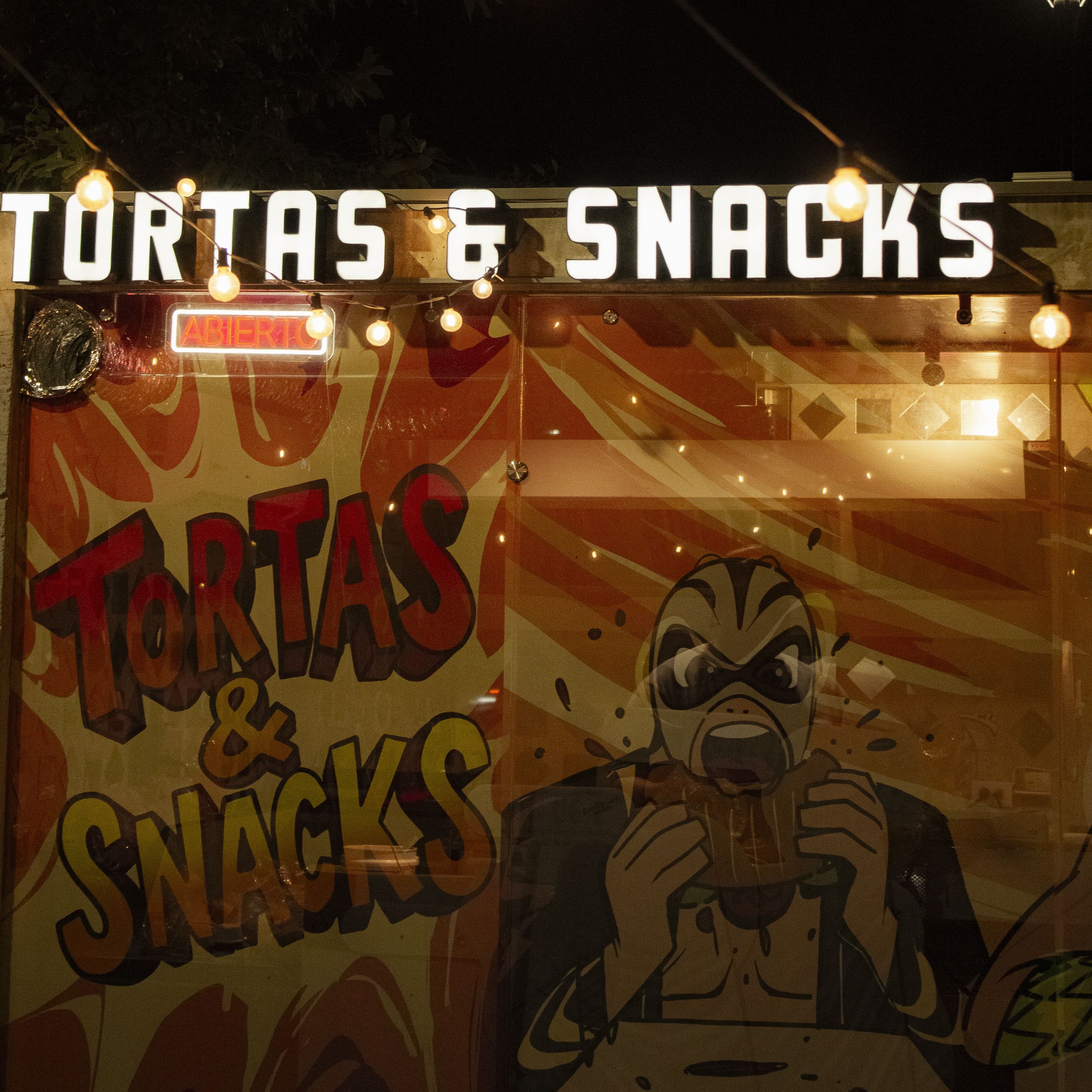 Two friends with contrasting masks laughing